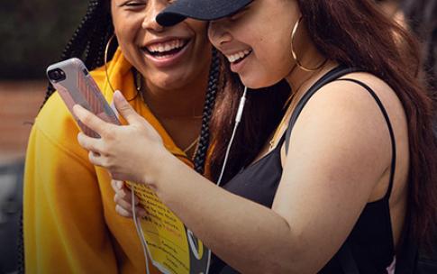 Two students looking at a cell phone