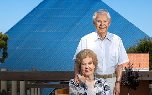 Mike and Arline Walter standing in front of the Walter Pyramid at Cal State Long Beach.