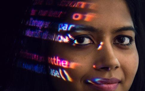 student with computer coding on face