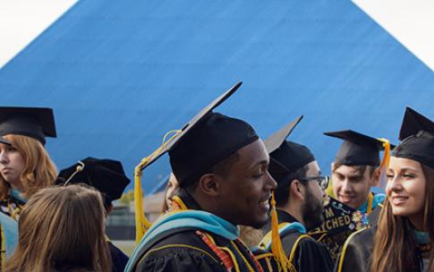 Students in front of Pyramid at graduation