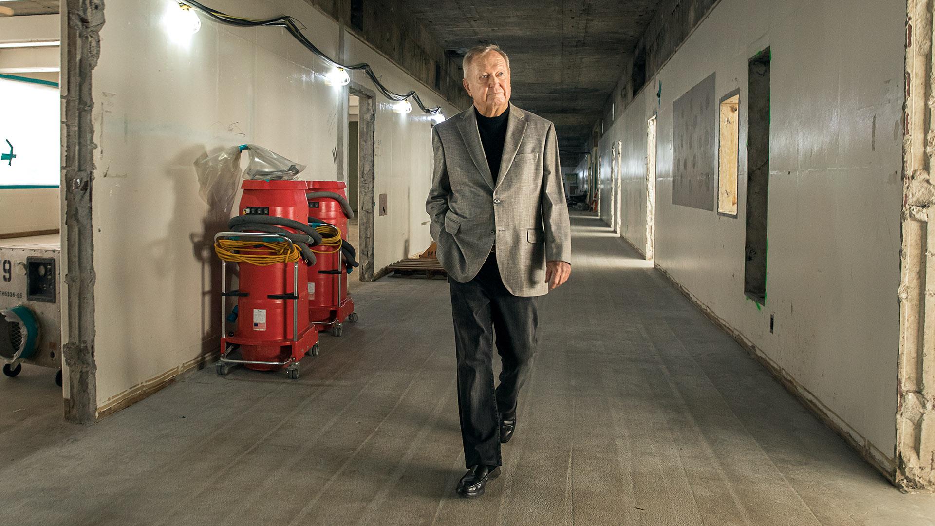 Donor Bob Murphy walks through building under construction