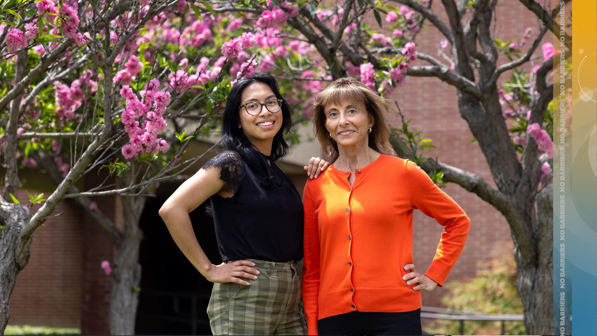 Two women standing in front of building