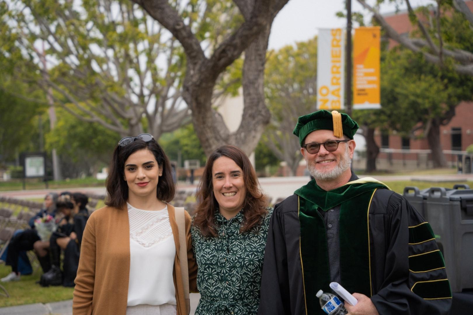 Faculty stand smiling at Ling/ASLD graduation ceremony.