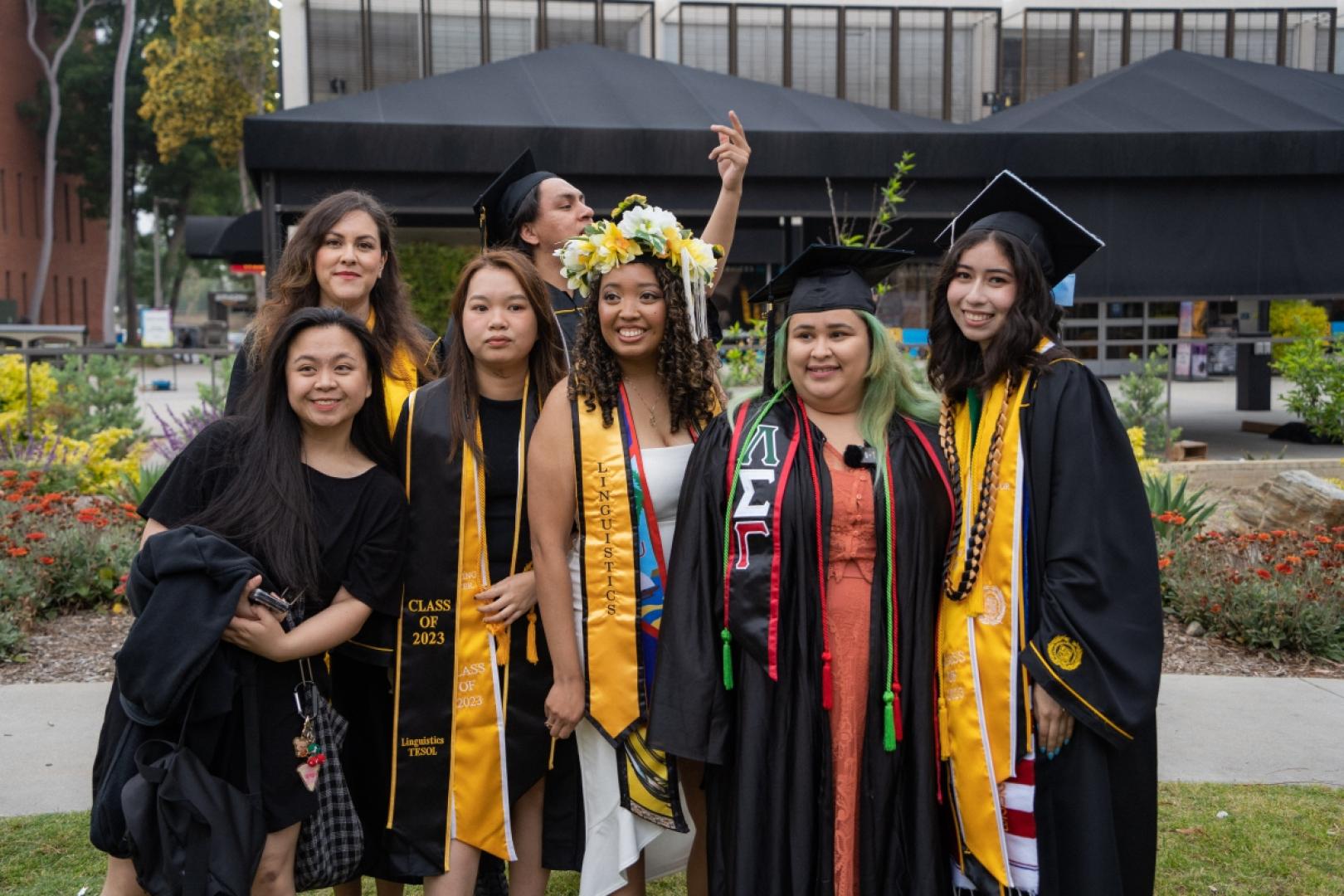 Group of graduating students stand together.