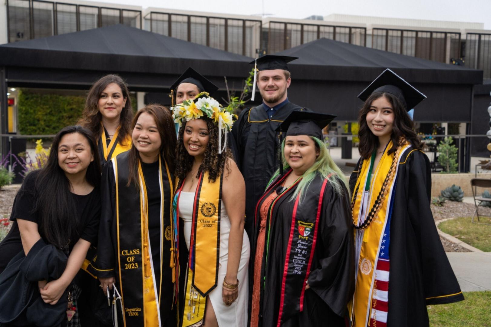 Group of graduating students stand together.