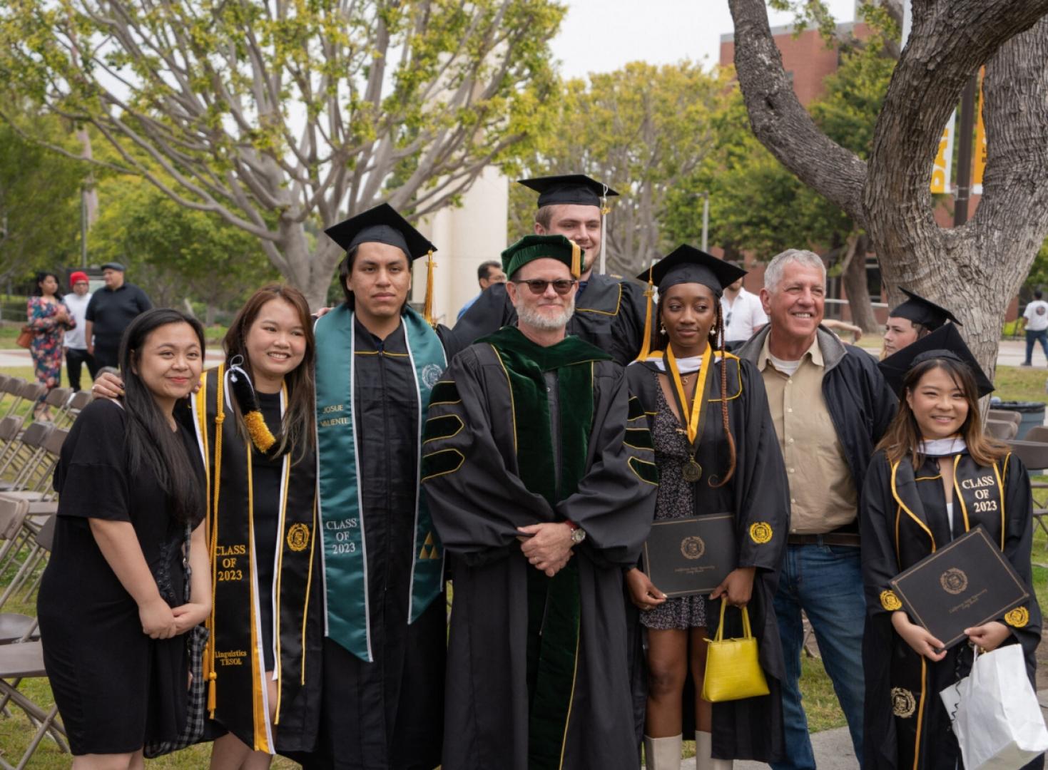 Group of graduating students stand together.