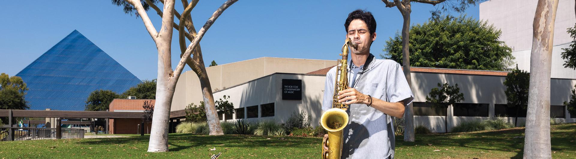 Christian Basabro plays the saxophone with Pyramid behind him