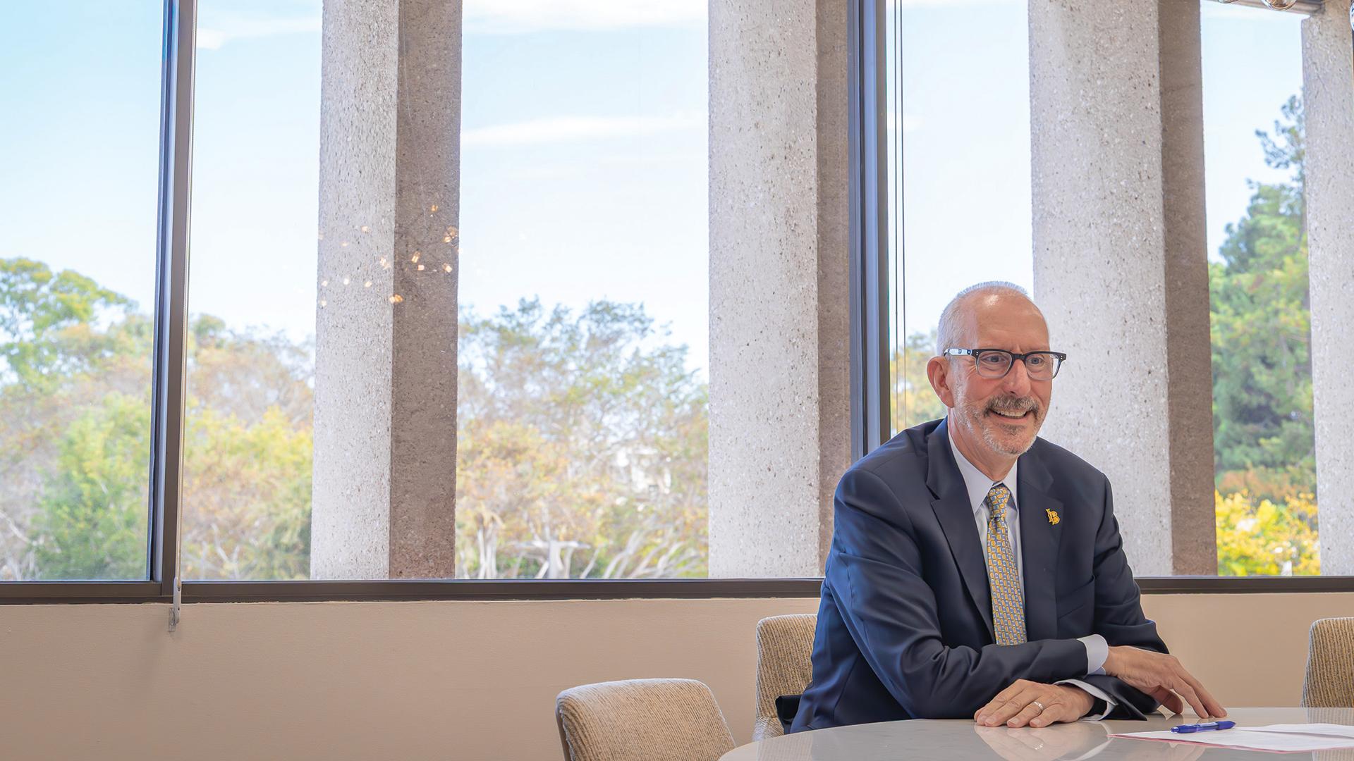 CSULB President Andrew Jones seated near windows
