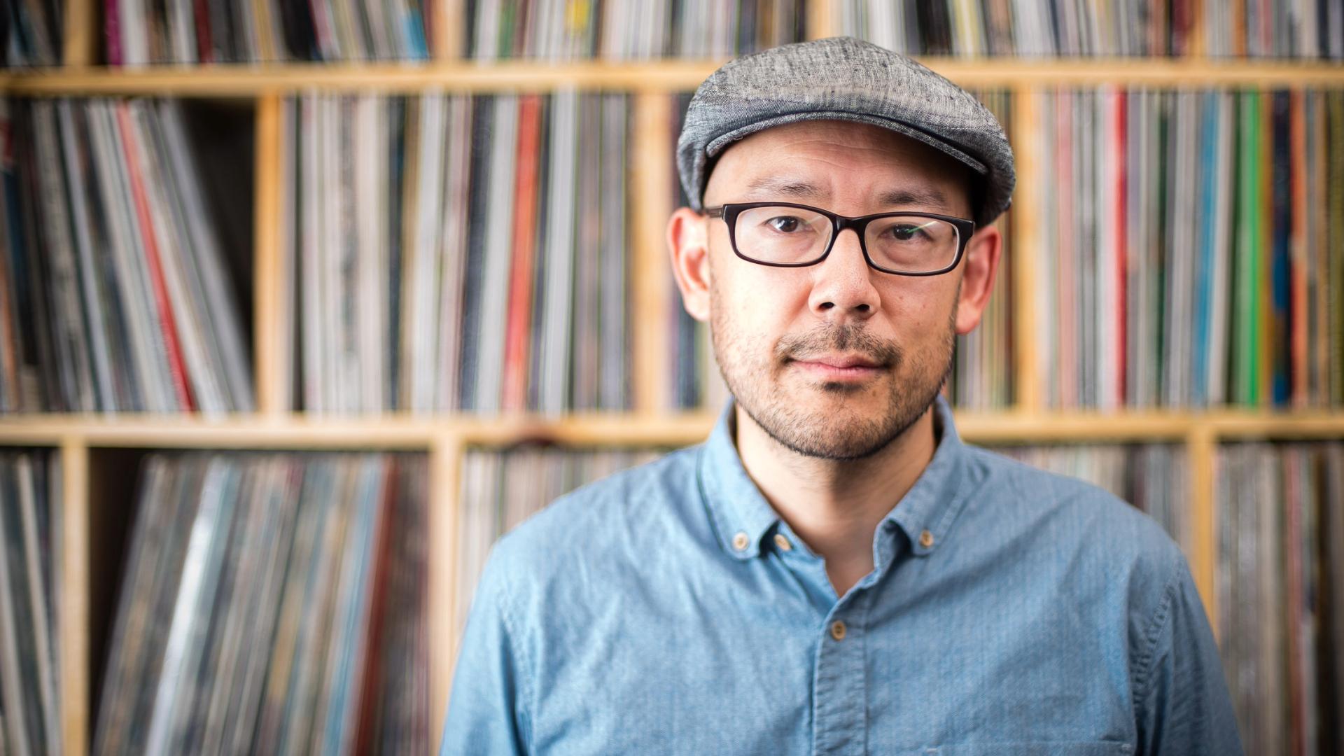 Professor Oliver Wang in front of his vinyl albums