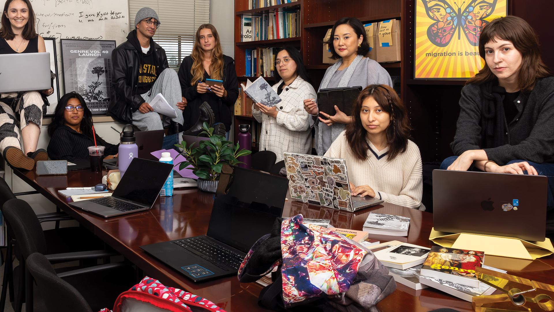 Students and a professor inside Genre's conference room