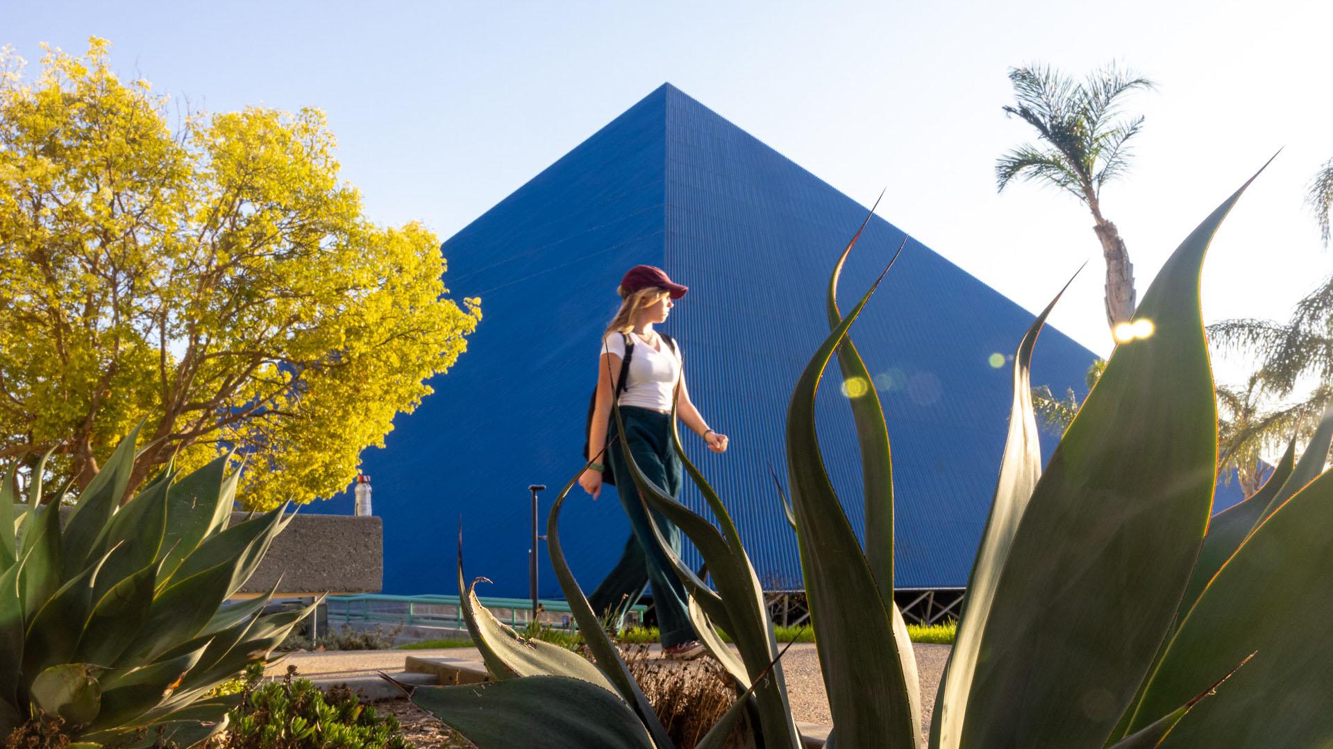A woman walking by CSULB's pyramid