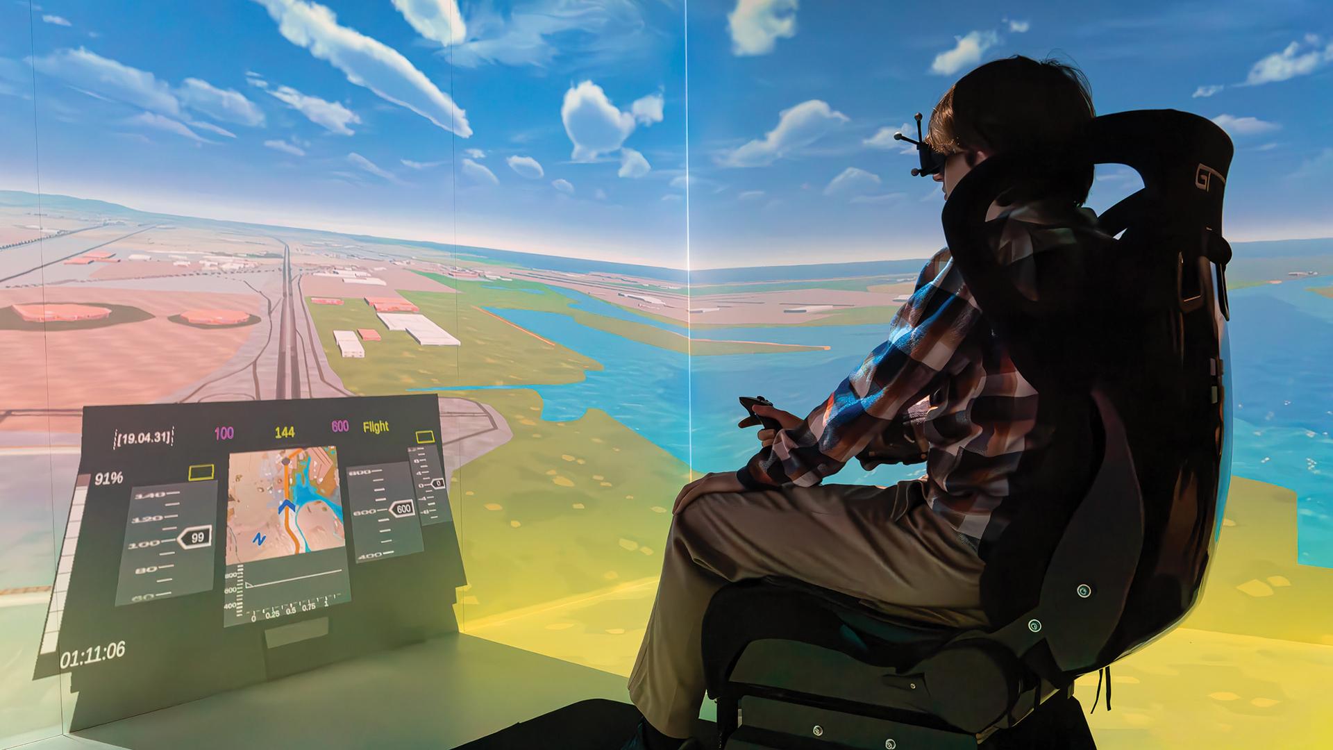 A CSULB student using a flight simulator