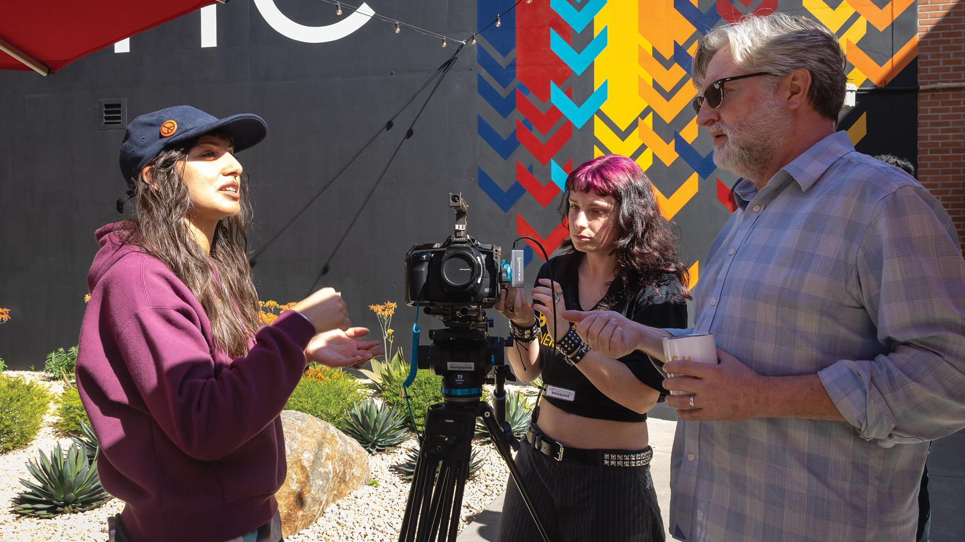 Professor Kent Hayward, right, consults with students
