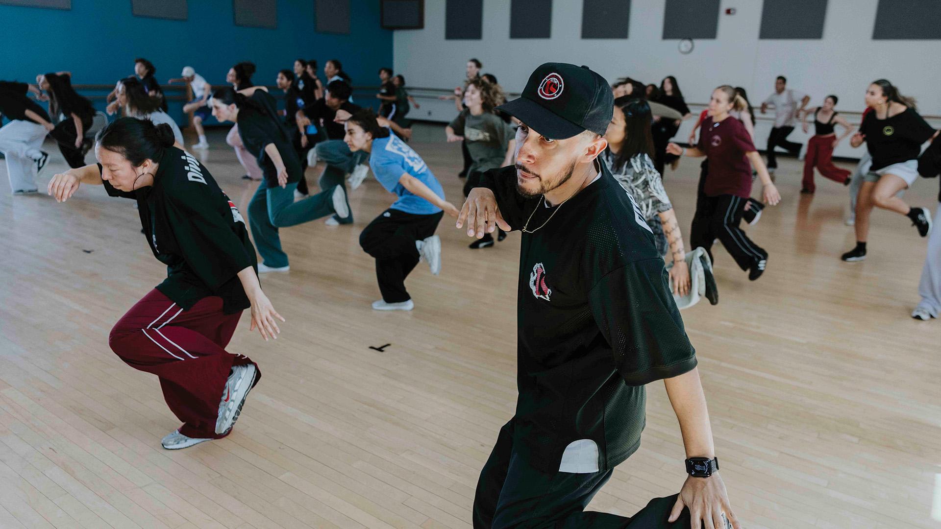 Two members of Versa-Style Street Dance Company lead CSULB students in the studio