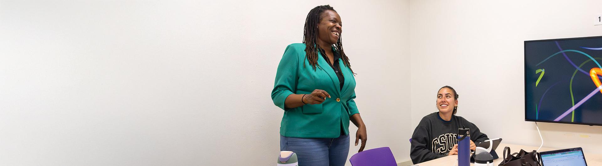 Jolan Smith, standing, teaches in the classroom