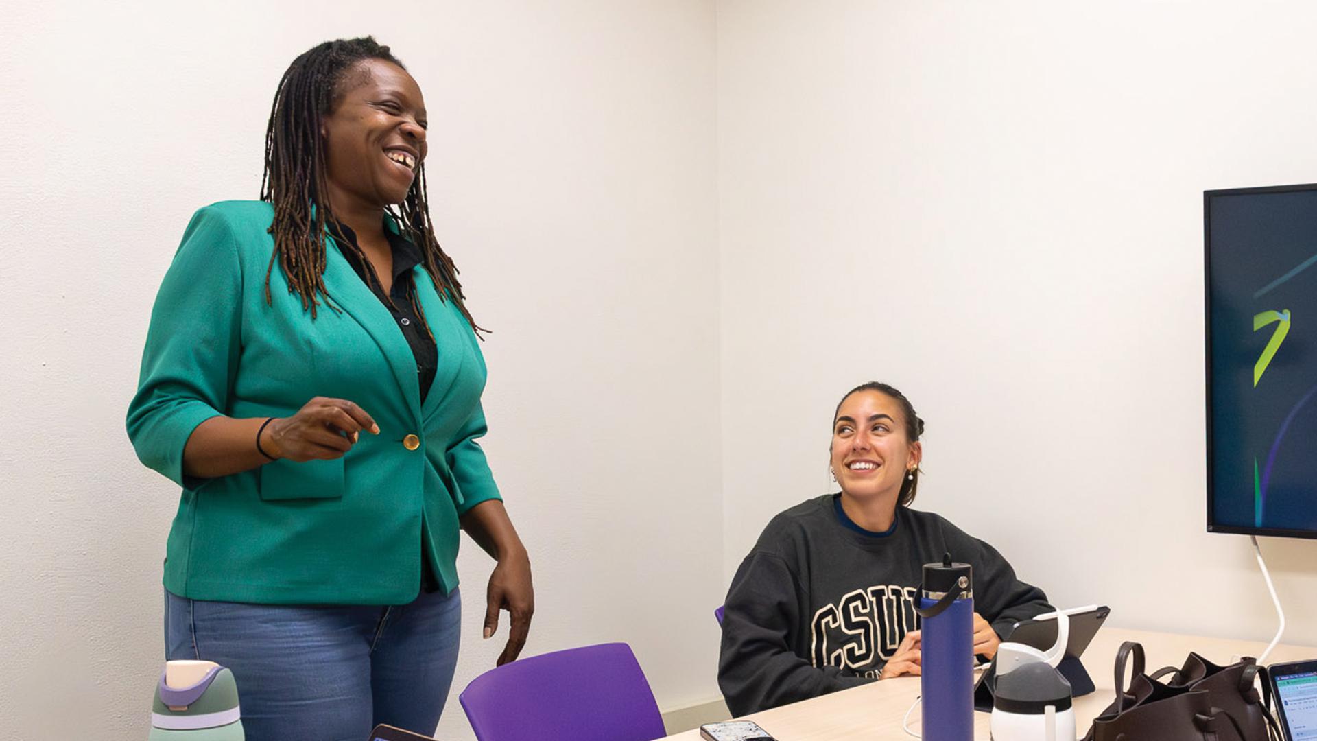 Jolan Smith, standing, teaches in the classroom