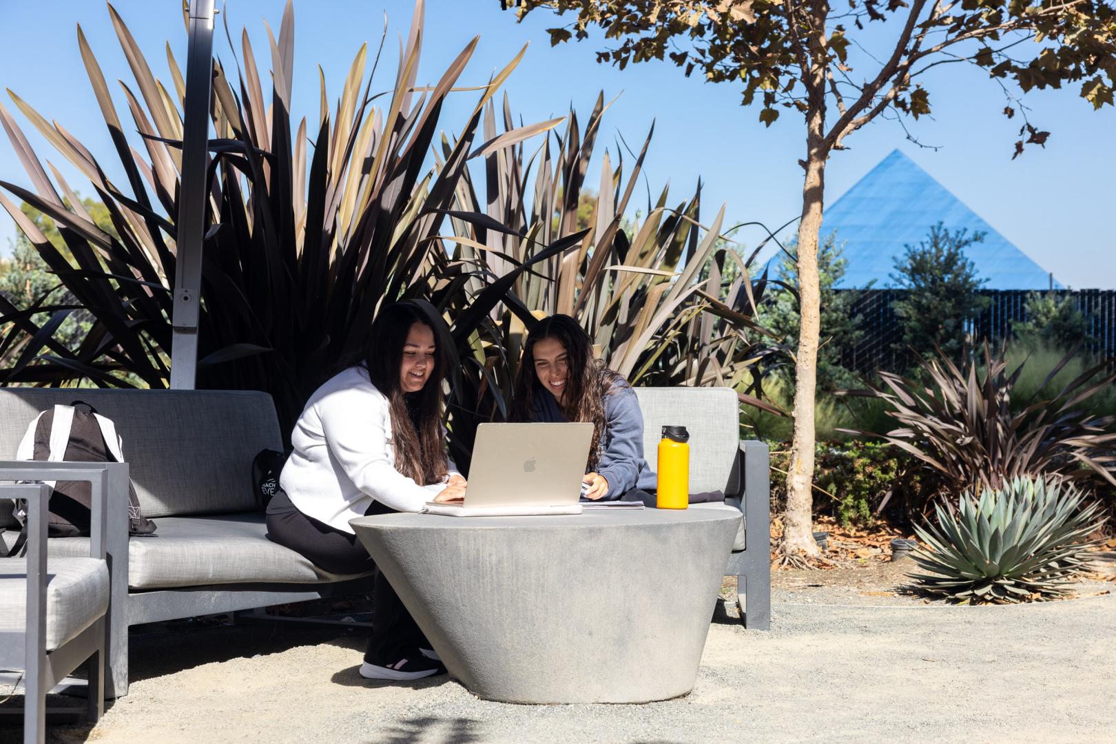 Two professionals reviewing work together