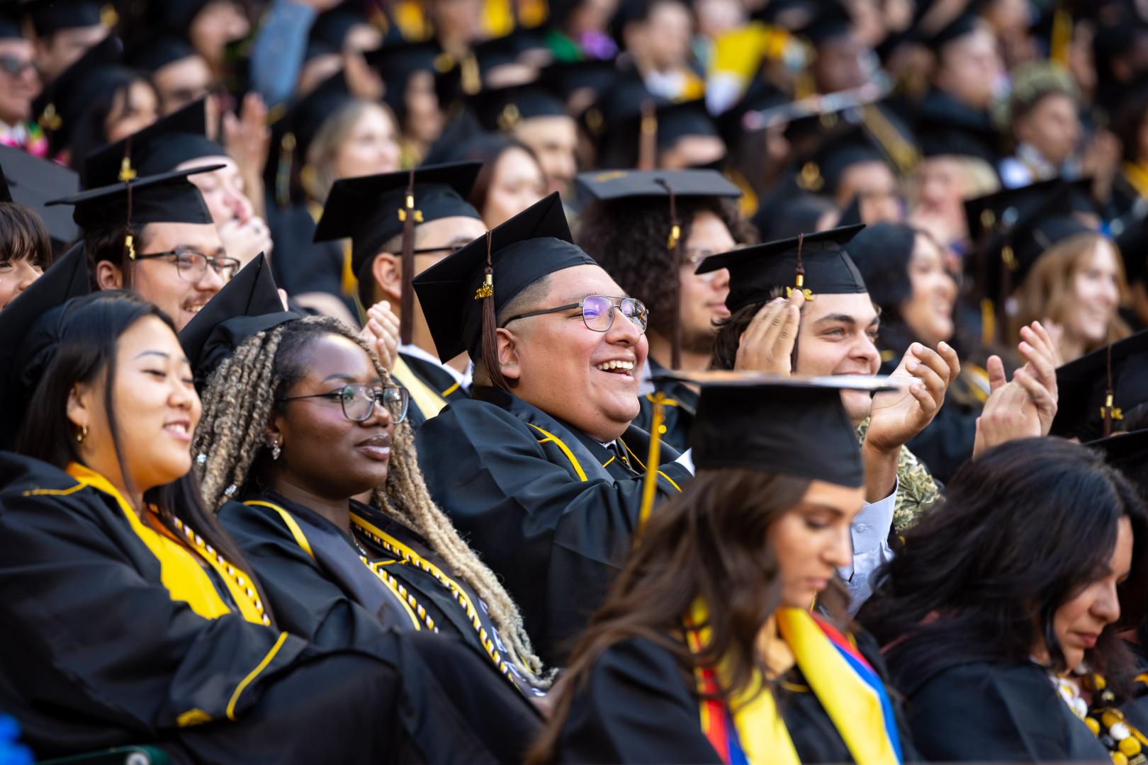 CCSULB graduates in caps and gowns celebrating at commencement