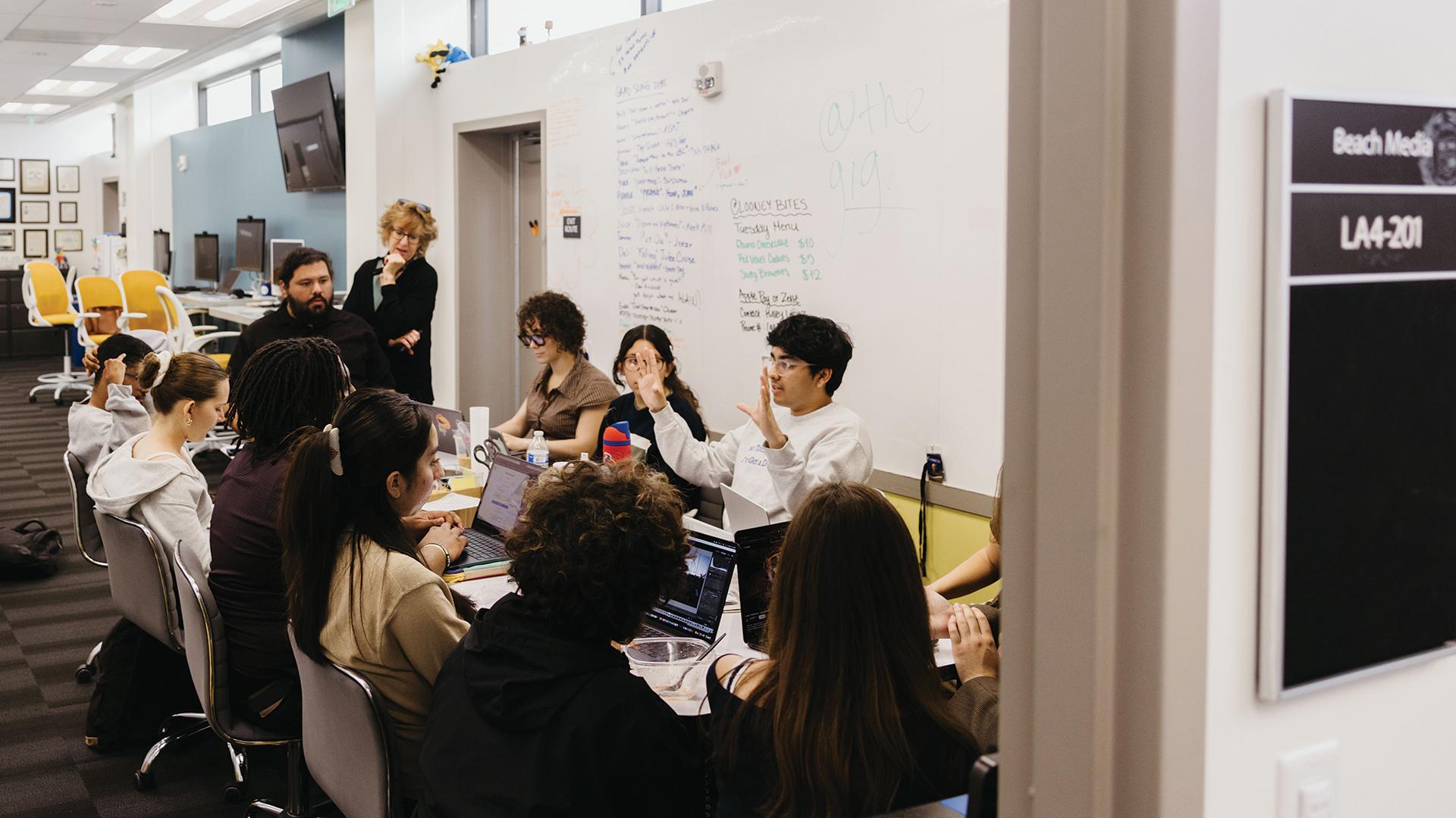 A meeting inside the Long Beach Current newsroom