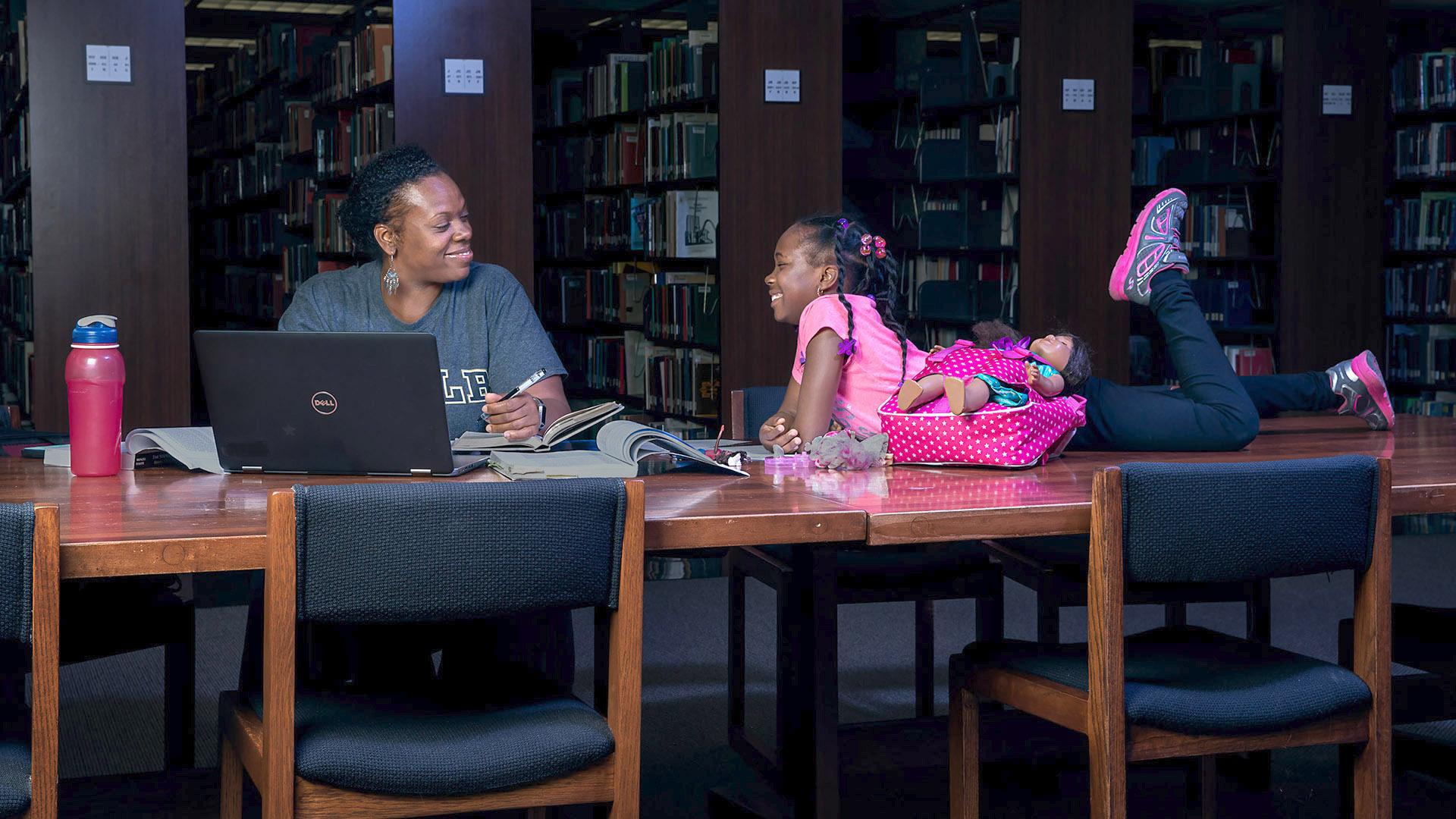 Cara Askew studies with her daughter.