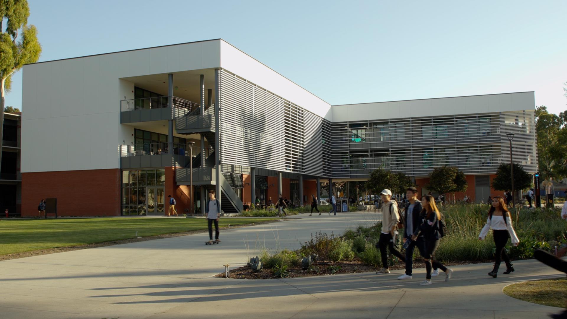 Students walk past the new CCPE building.