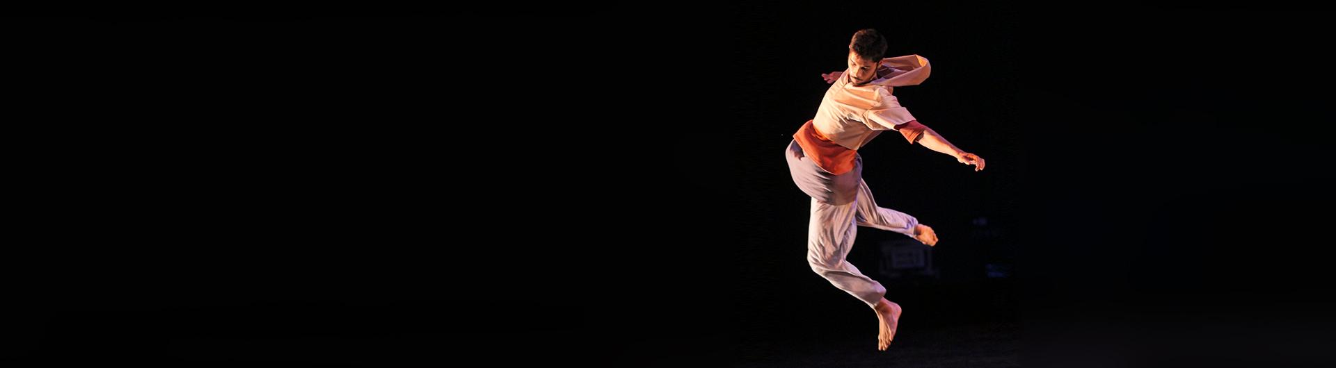 Hip Hop Dancer in white hoodie jumps