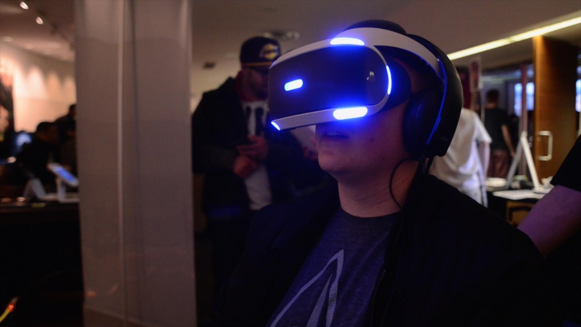 Student playing game with VR glasses.