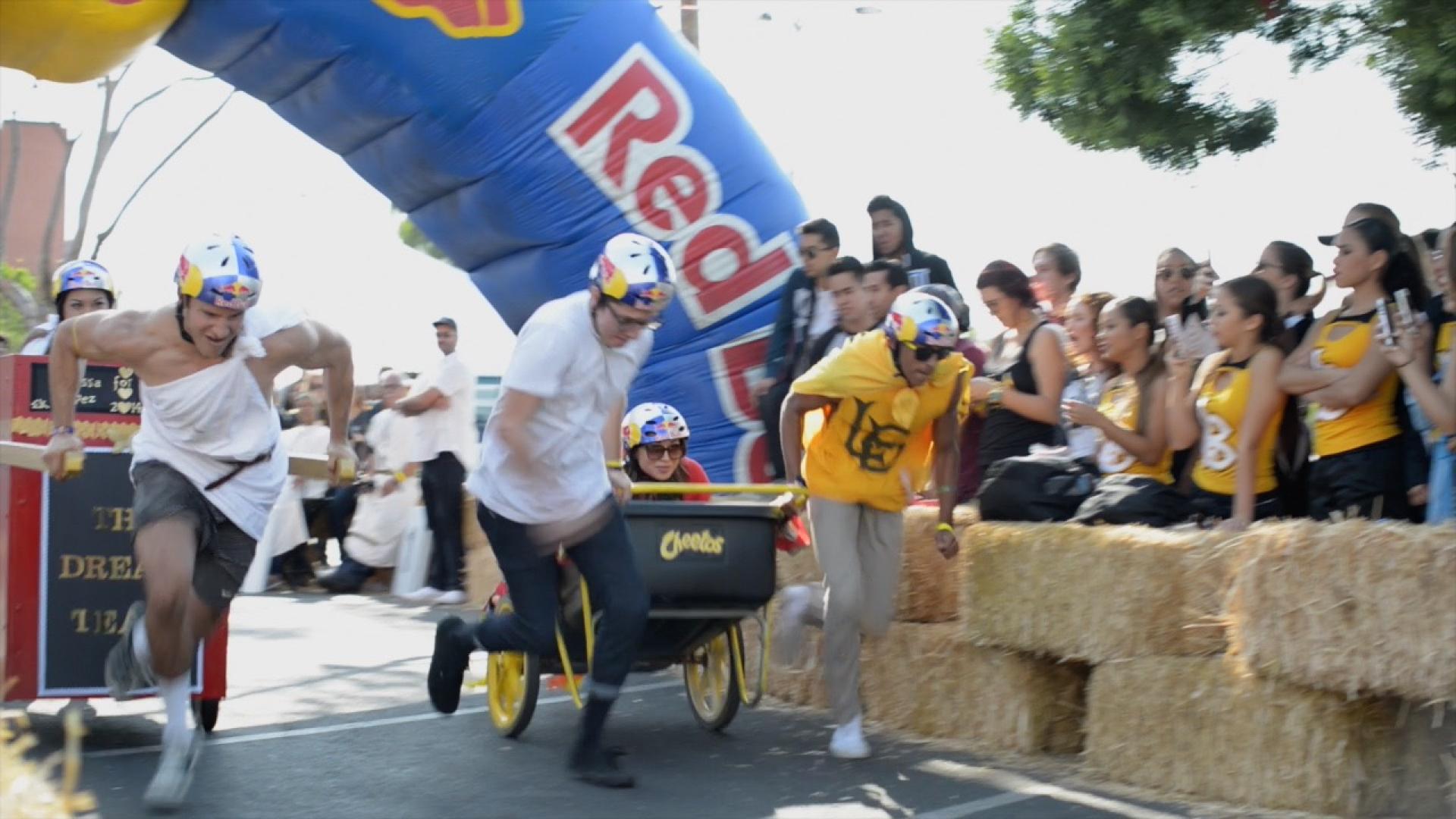 Students competing in Red Bull Chariot race at Homecoming
