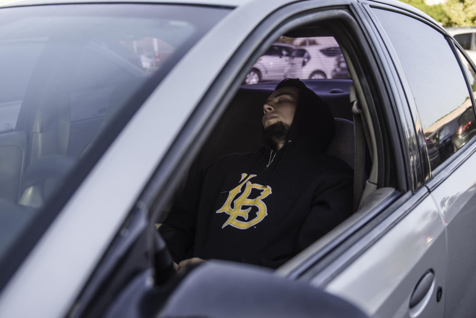 Guy sleeping in car
