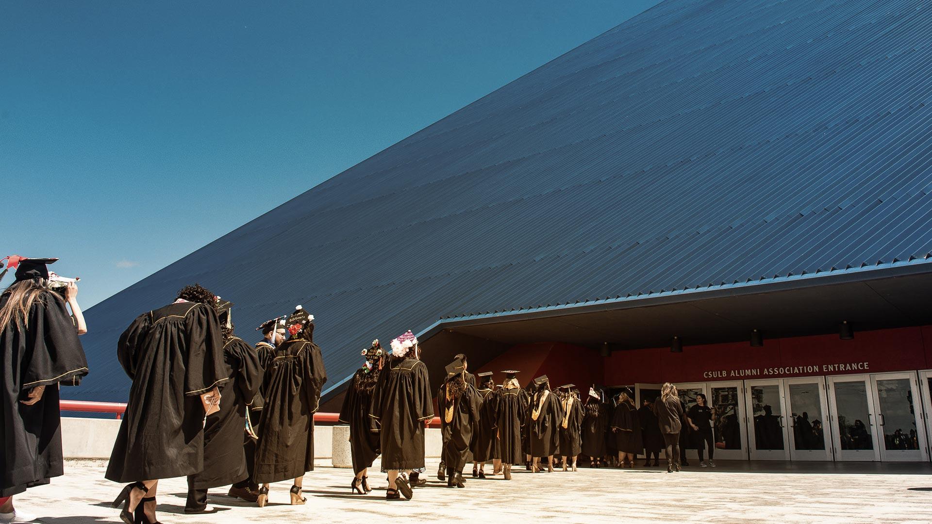 CSULB Graduates walking towards the pyramid