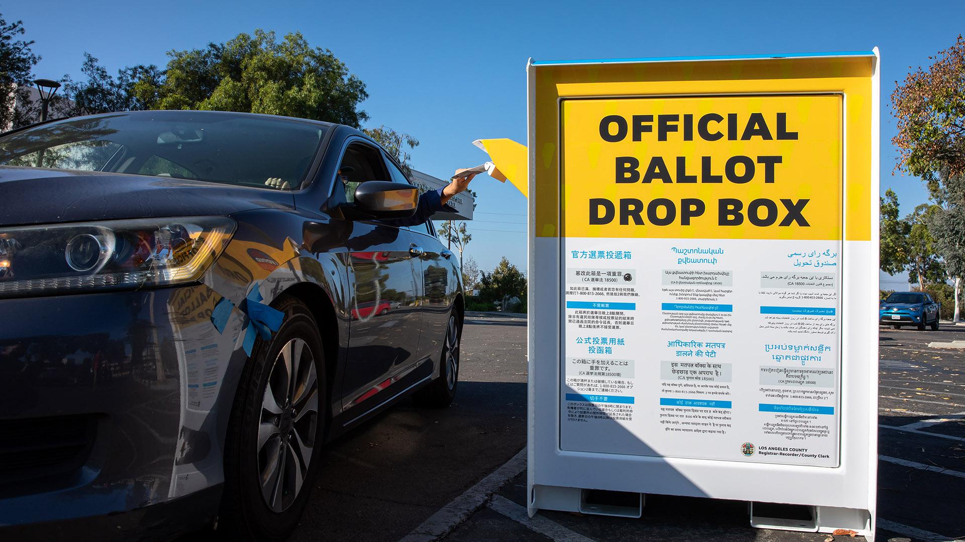 Driver dropping ballot into ballot box