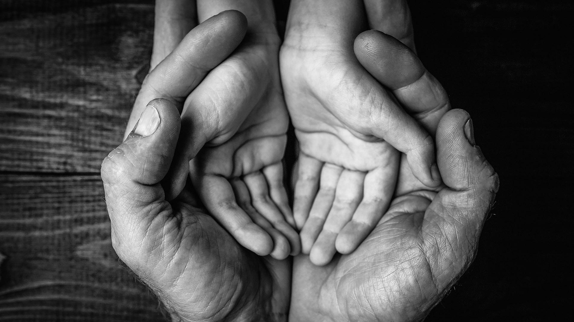Father holding child's hands