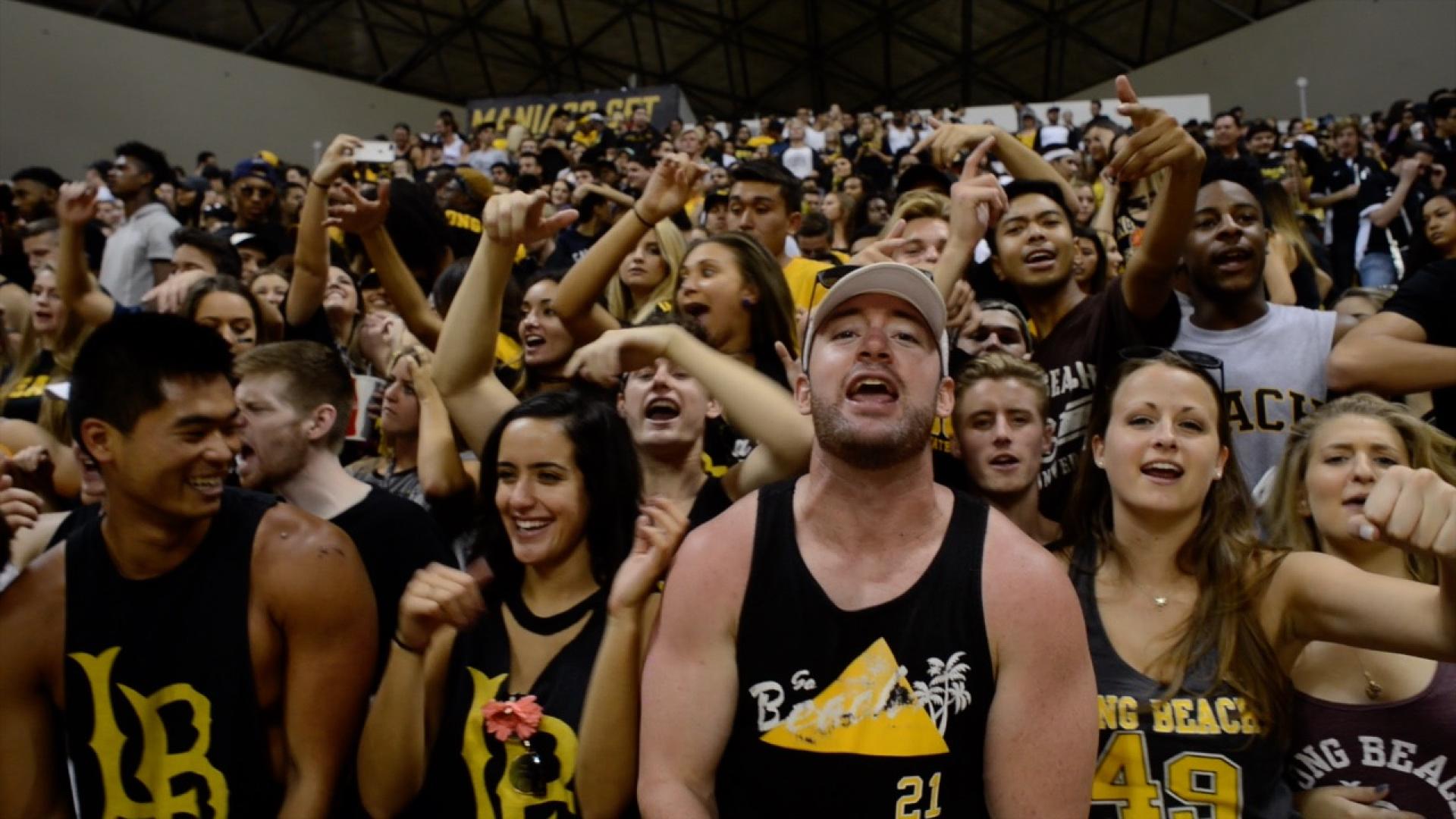 Students cheer at a basketball game.