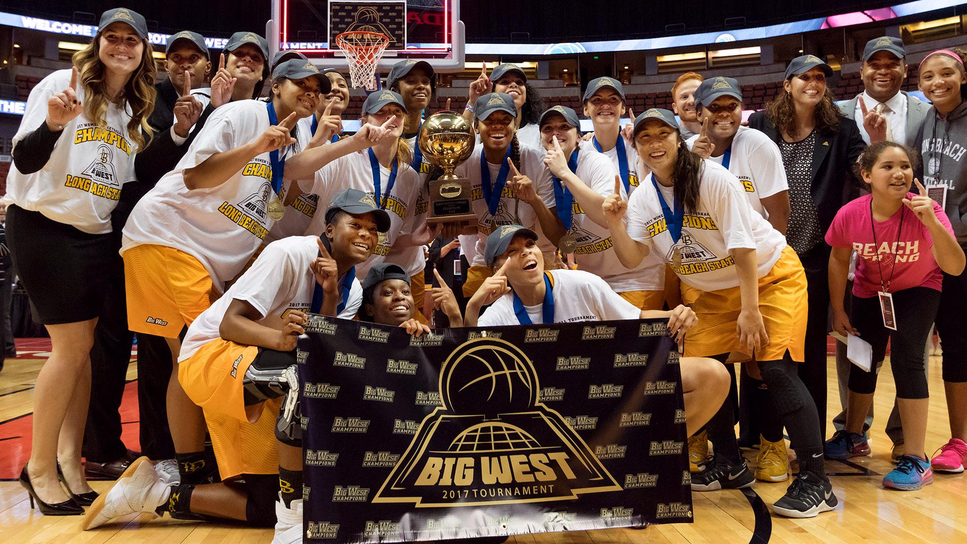 Women's basketball team holding the Big West Championship trophy.