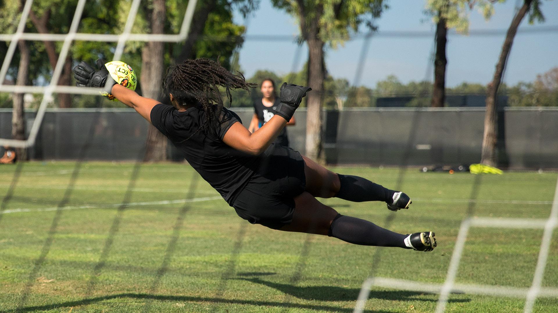 Soccer goalie blocks shot