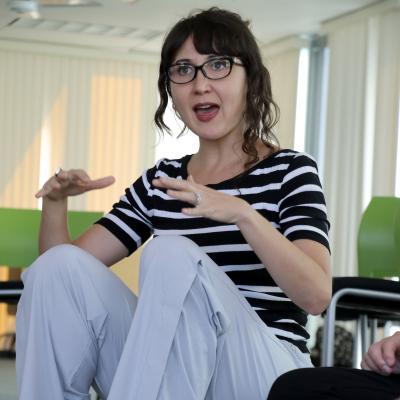 Photo of Andrea Caban sitting and teaching