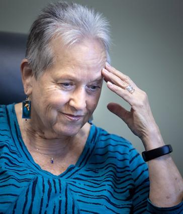 Alyce LaViolette puts her left hand to her head.