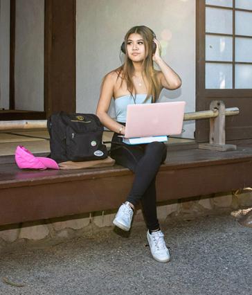 Student works on pink computer in Japanese Garden