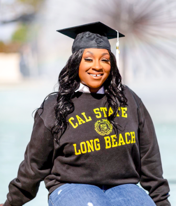 Graduate Janay Taylor in CSULB sweatshirt and cap