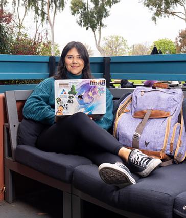 Amy Figueroa-Orozco holds up book