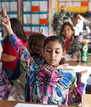 Young student raising her hand