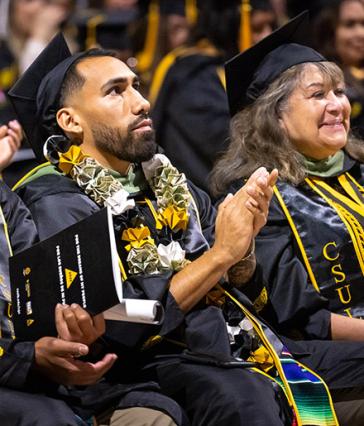 Recent Latino graduate clapping