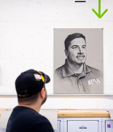 Veteran Jose Reynoso looks at his portrait
