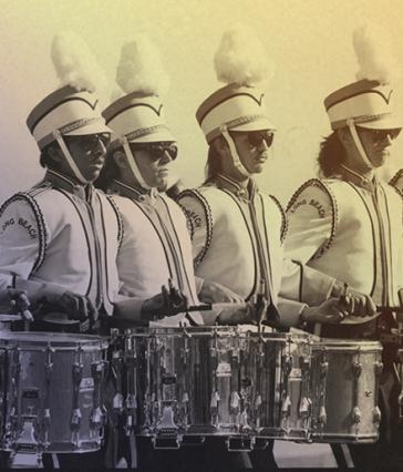 Four drummers in marching band uniforms