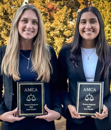 Two students hold AMCA plaques
