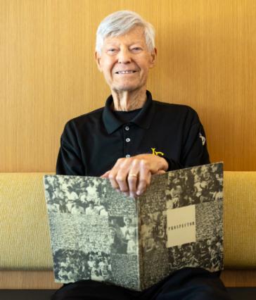 Dale Fairbanks holds a 1954 yearbook