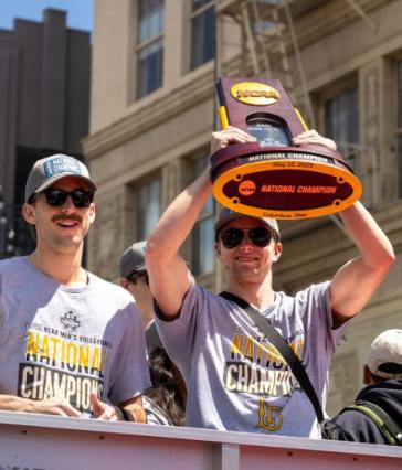 Men's Volleyball players with championship trophy
