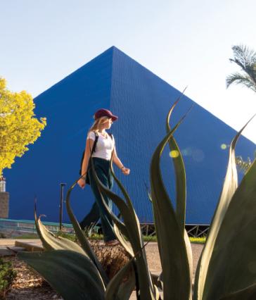 A woman walking by CSULB's pyramid