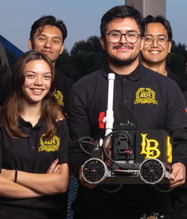 Students pose with model car