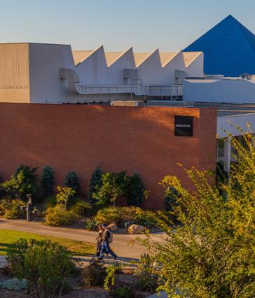 People walk in front of campus buildings